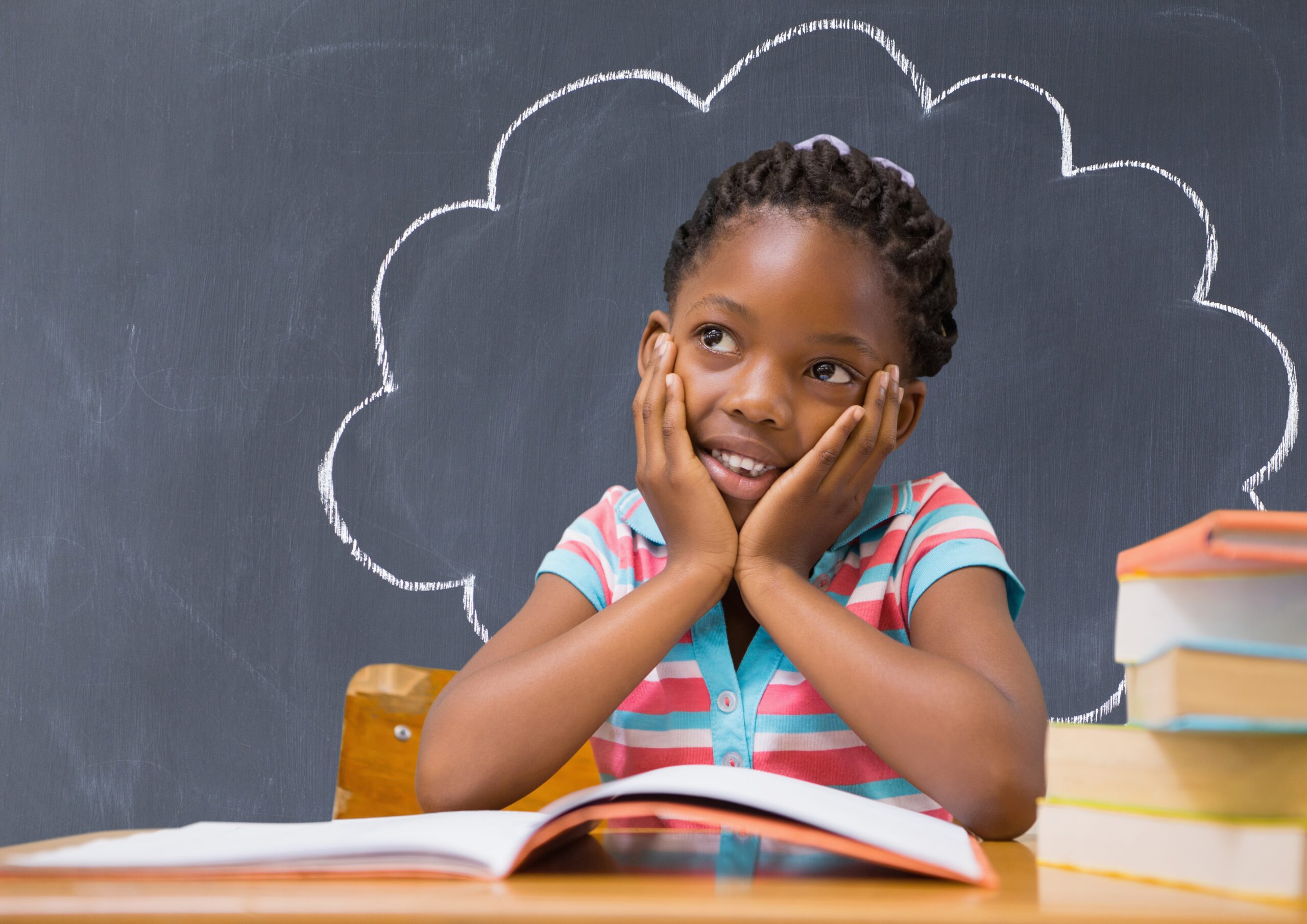 Thoughtful girl sitting at desk in the classroom