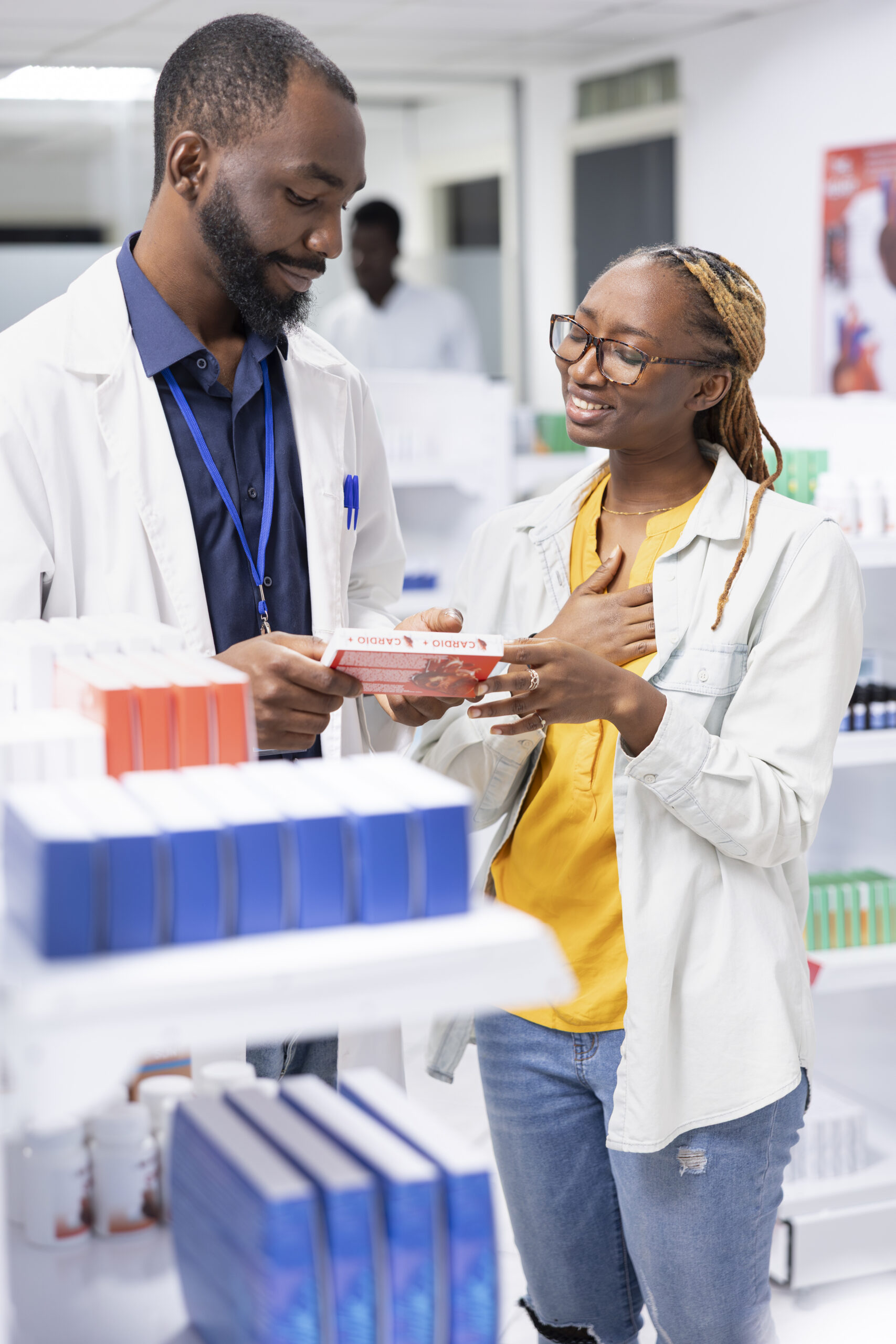 African american pharmacist providing personalized pharmacist service and medication guidance to a pharmacy customer, discussing drugstore medications, vitamins and health products.